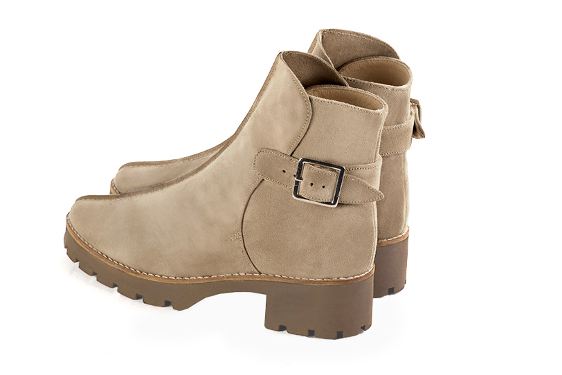 Tan beige women's ankle boots with buckles at the back. Round toe. Low rubber soles. Rear view - Florence KOOIJMAN